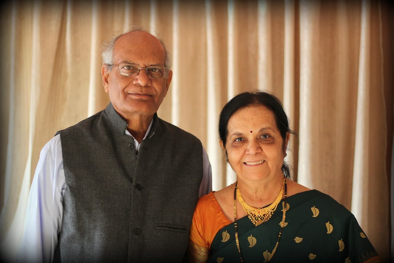 An older couple smiling together at home