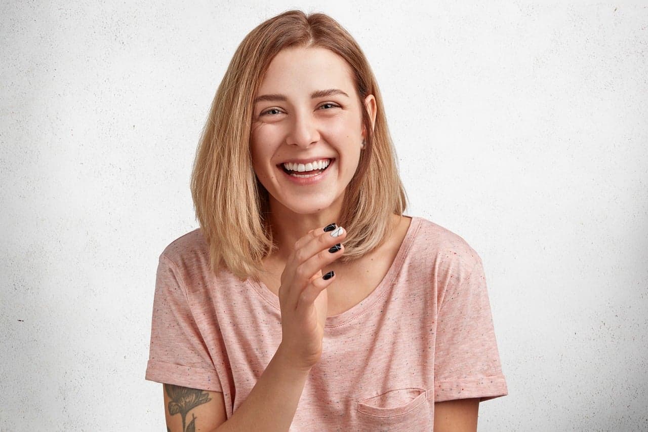 A woman laughing with a bright, natural smile